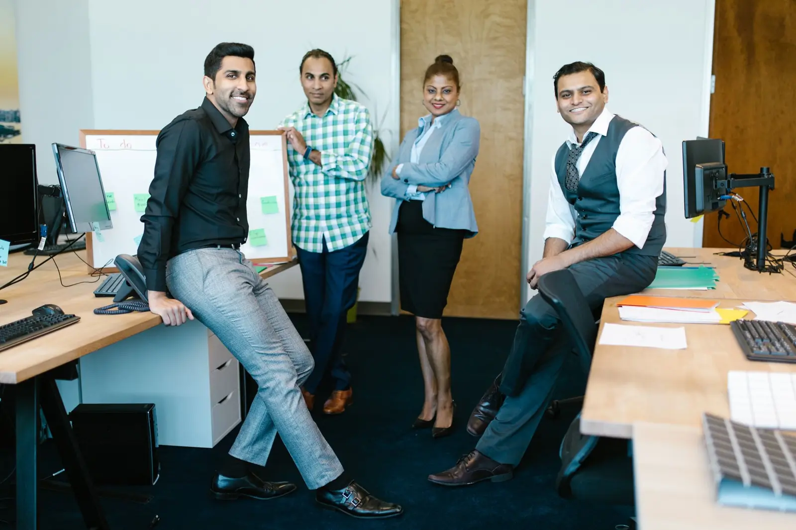 Members of a professional team standing together in their office