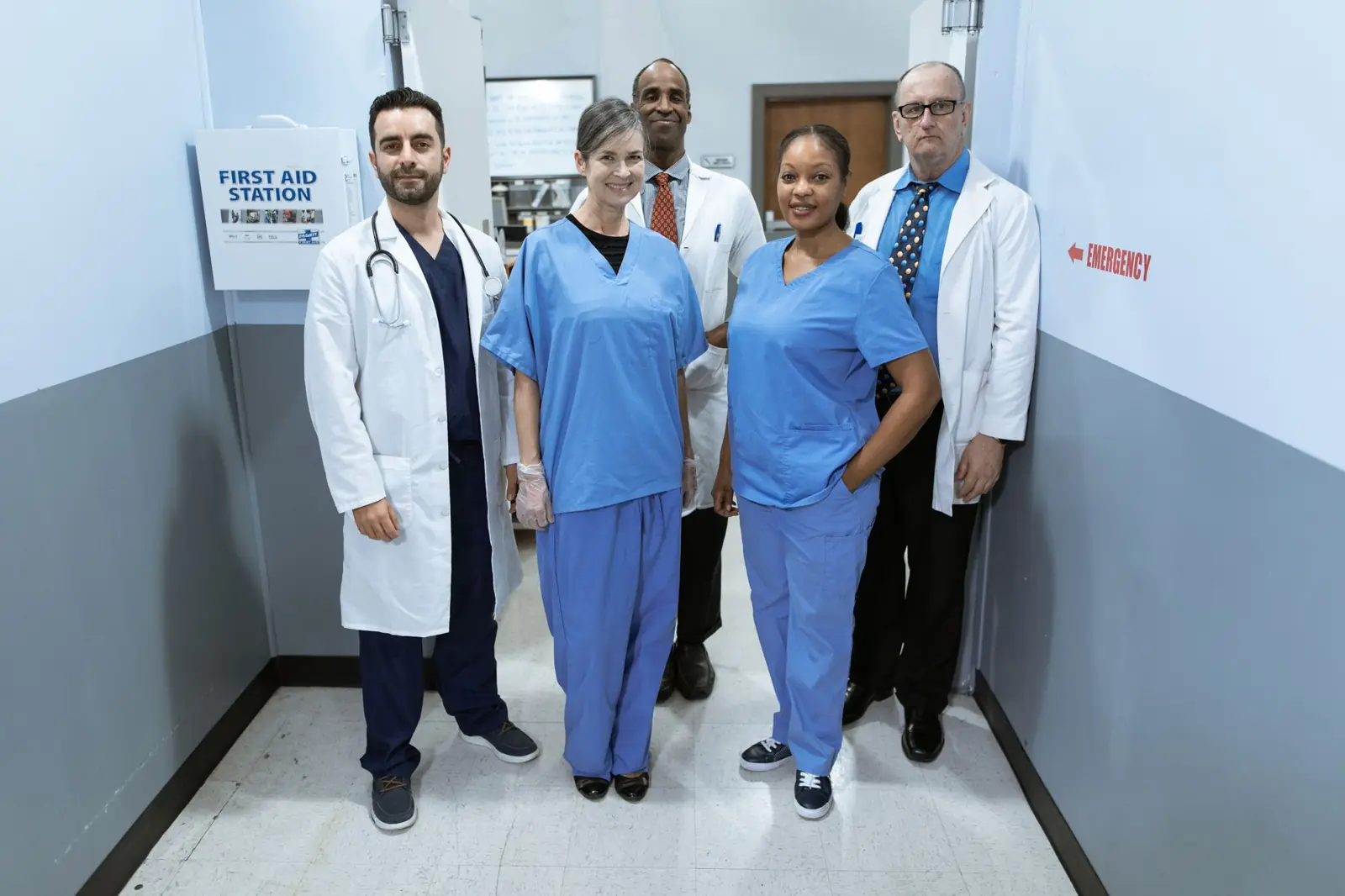 A group of doctors and nurses standing together in a hospital corridor